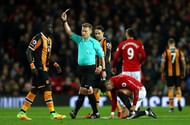 MANCHESTER, ENGLAND - FEBRUARY 01:  Mike Jones shows Oumar Niasse of Hull City a yellow card during the Premier League match between Manchester United and Hull City at Old Trafford on February 1, 2017 in Manchester, England.  (Photo by Clive Mason/Getty Images)